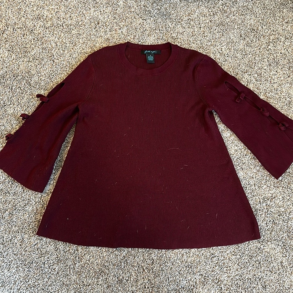 Maroon sweater with cutout bow detail sleeve